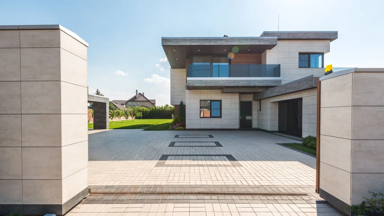 Contemporary two-story luxury home with spacious paved driveway and garden.