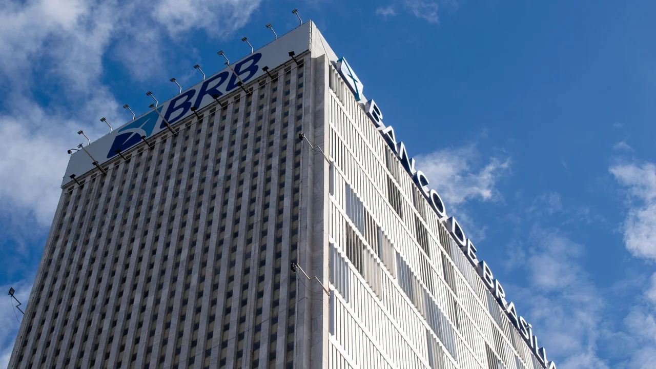 High-rise Banco de Brasília building with clear sky, capturing modern architecture against a vibrant blue background.