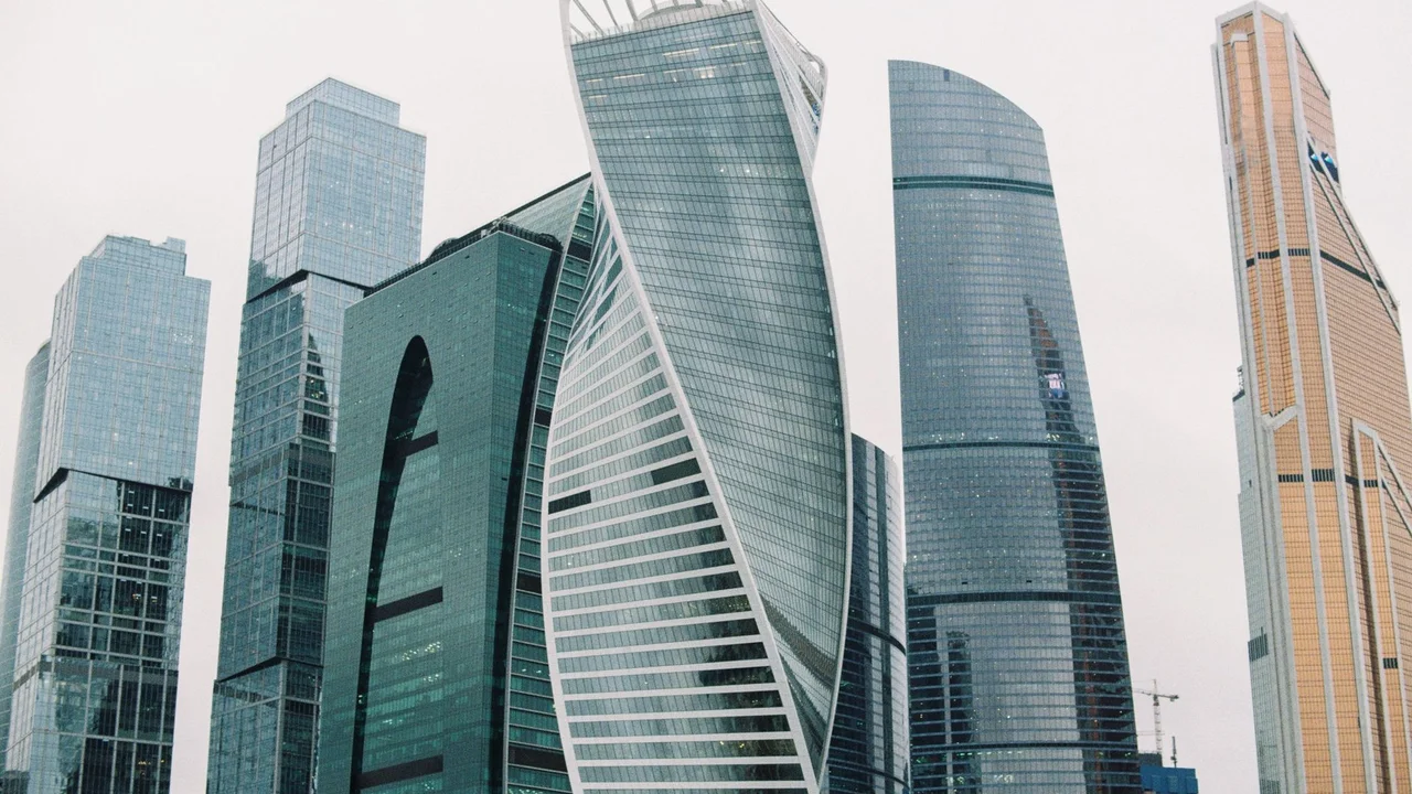 From below of contemporary skyscrapers in city street of megapolis in cloudy day
