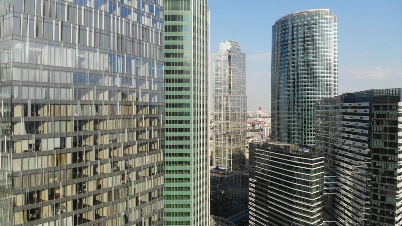 View of contemporary skyscrapers in Moscow with reflective glass facades on a clear day.