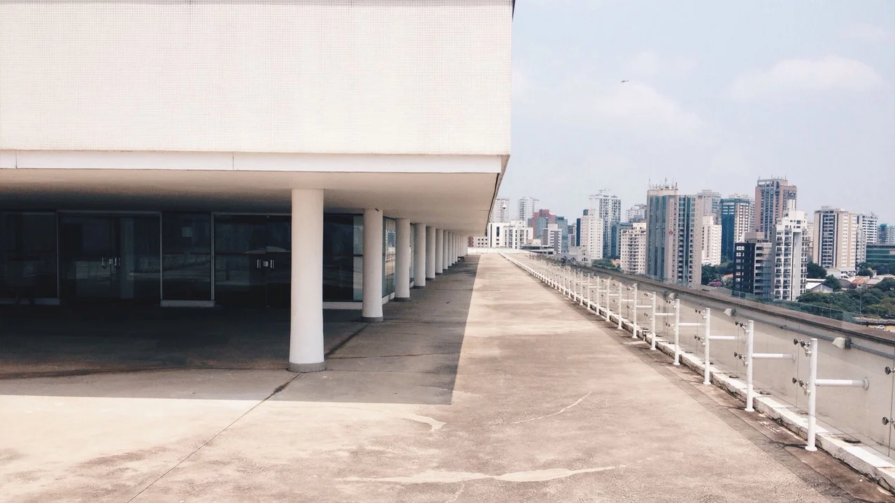 View of São Paulo's skyline from a modern, minimalist building terrace.