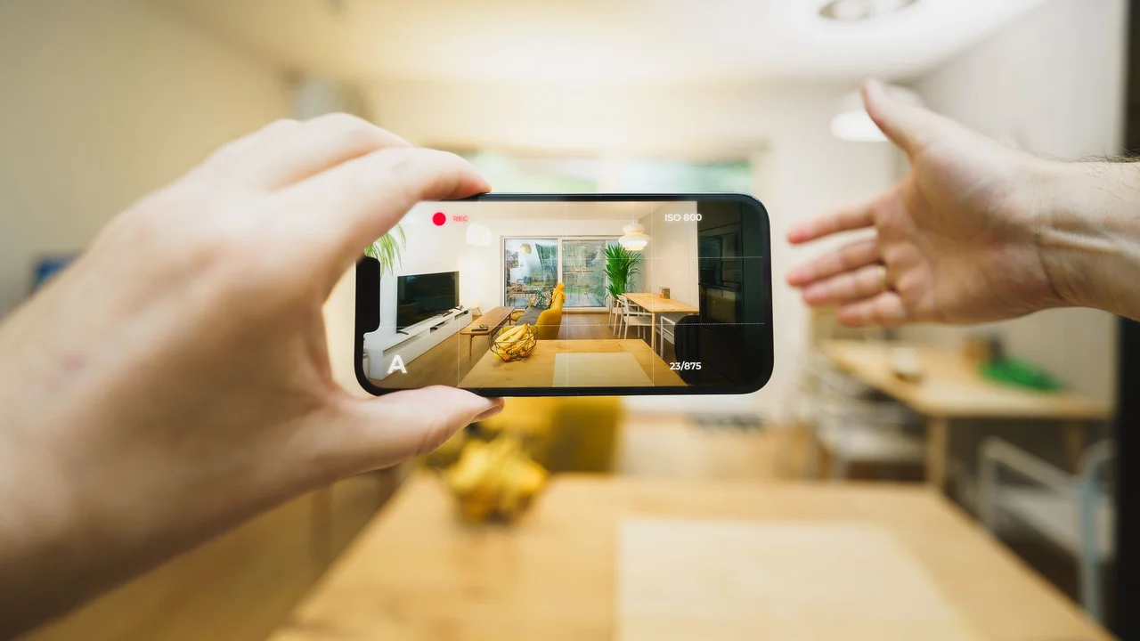 Interactive virtual tour of a contemporary living room using a smartphone.