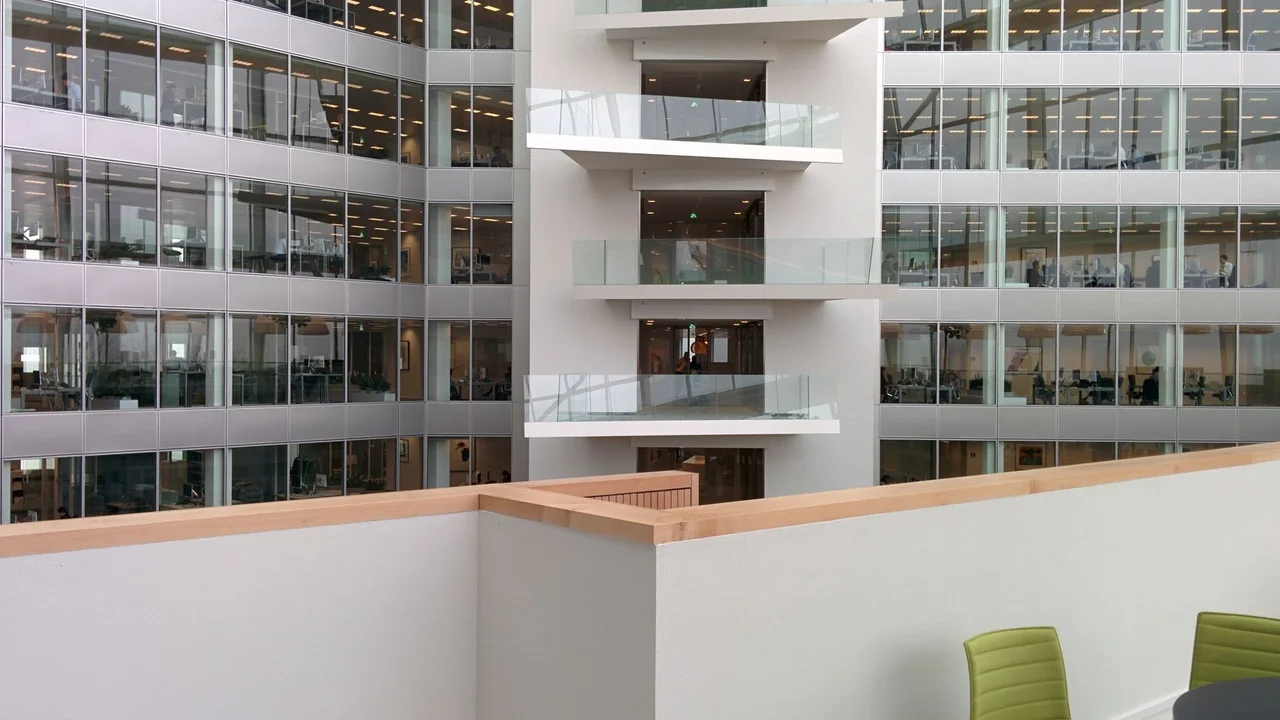 Sleek interior of a modern office building showcasing open balconies and contemporary design.