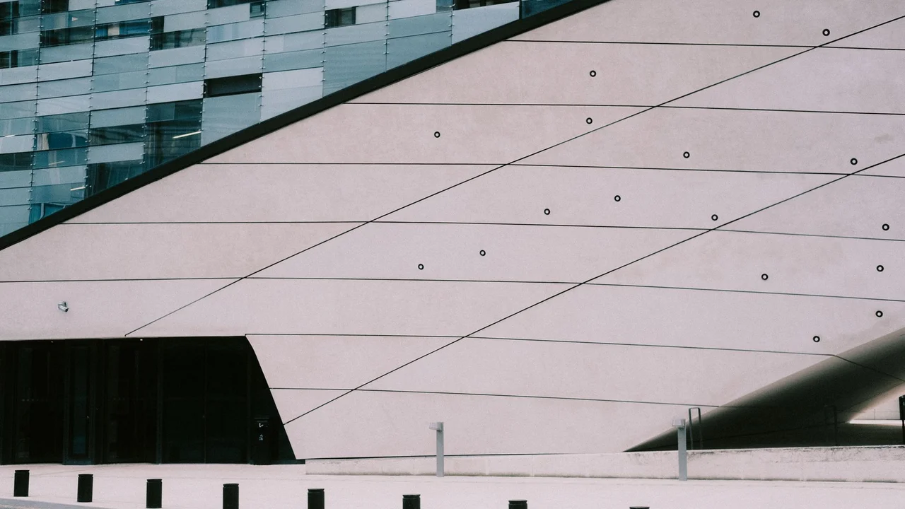 Contemporary building facade featuring sleek lines and modern geometric design elements.